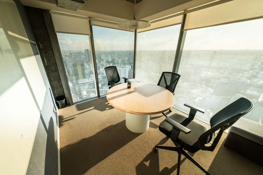 A modern meeting room with a wide city view