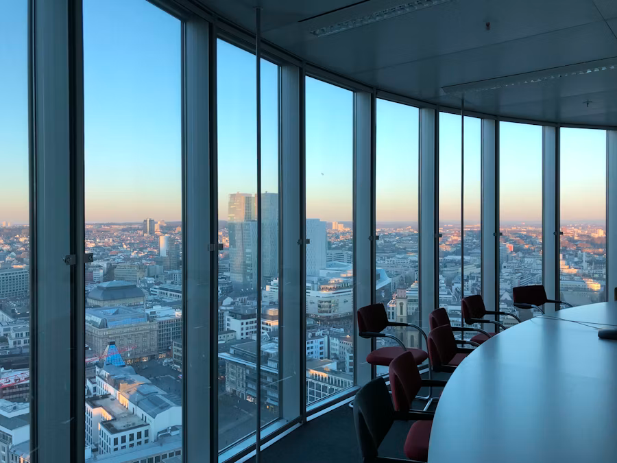 Colleagues seated together near a bright window discussing a long-term financial plan