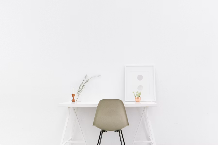A clean wooden table and chair set in a softly lit minimal room